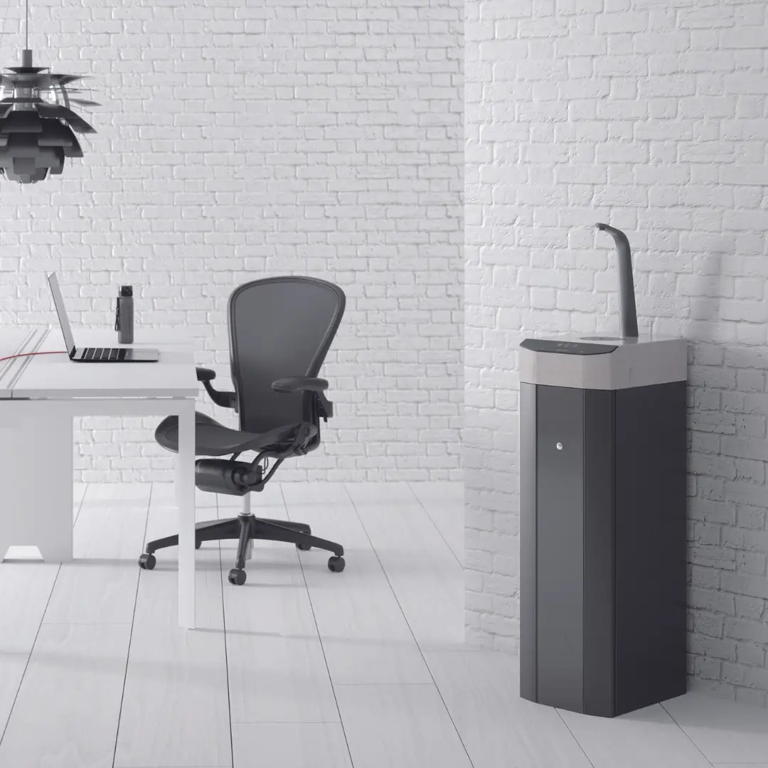 a desk with a laptop and a speaker